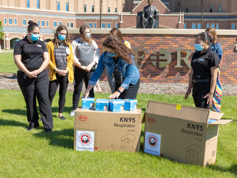 Health care workers open donations of KN95 masks from Panda Express outside Sanford Medical Center in Fargo, North Dakota. (Photo by Jose D. Medina Medrano, Sanford Health)
