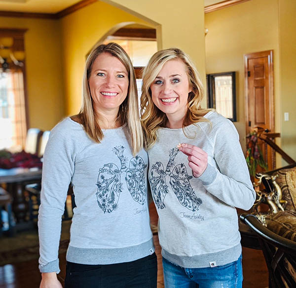 Stacy Peters and Ashley Ballou-Bonnema stand in Peters' home