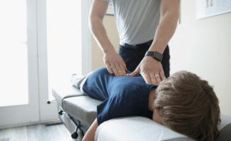 A boy receives chiropractic treatment