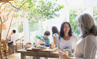 Multi-generational family talking in the kitchen