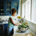 Woman stands at her kitchen sink