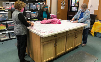 Sewing group ties ‘knots of love’ into blankets for patients