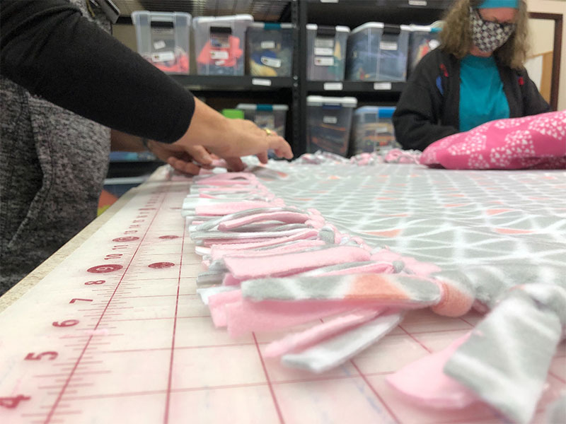 Congregation members of First Presbyterian Church create blankets and tie 'knots of love' for breast cancer and mastectomy patients.
