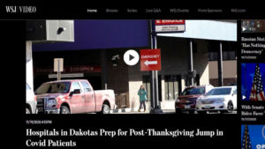 Wall Street Journal Video website screen shot with exterior photo of medical clinic with people walking by, with headline "Hospitals in Dakotas Prep for Post-Thanksgiving Jump in Covid Patients"