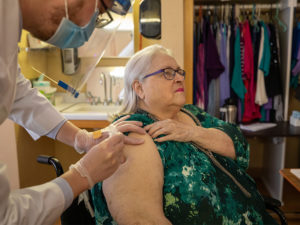 Resident Karen L. Brinkman receiving the COVID-19 vaccine.