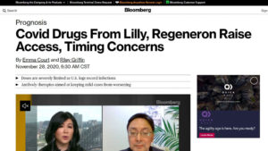 Bloomberg website screen shot with two people on video under headline "Covid Drugs From Lilly, Regeneron Raise Access, Timing Concerns"