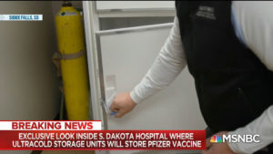 MSNBC video screen shot of pharmacist opening white freezer above headline "Sioux Falls, SD, Exclusive look inside S. Dakota hospital where ultracold storage units will store Pfizer vaccine"