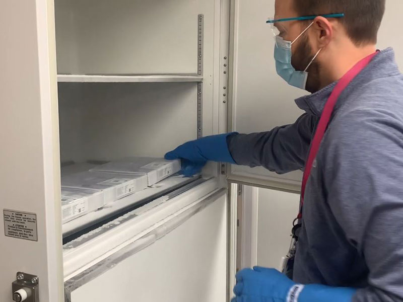 SLIDE SHOW (2/5): A Sanford Health pharmacy worker places the first shipments of COVID-19 vaccine in ultracold storage at Sanford Medical Center Fargo. (Photo by Nathan Aamodt, Sanford Health)