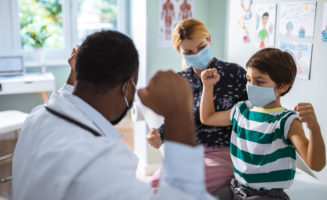 Close up of a pediatrician having a check up on his patient