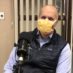 Dr. Geoffrey Haft smiles in a mask for the camera during podcast recording