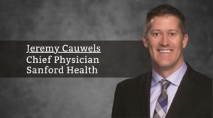 Dr. Jeremy Cauwels headshot on gray background with white text: "Jeremy Cauwels: Chief Physician Sanford Health"