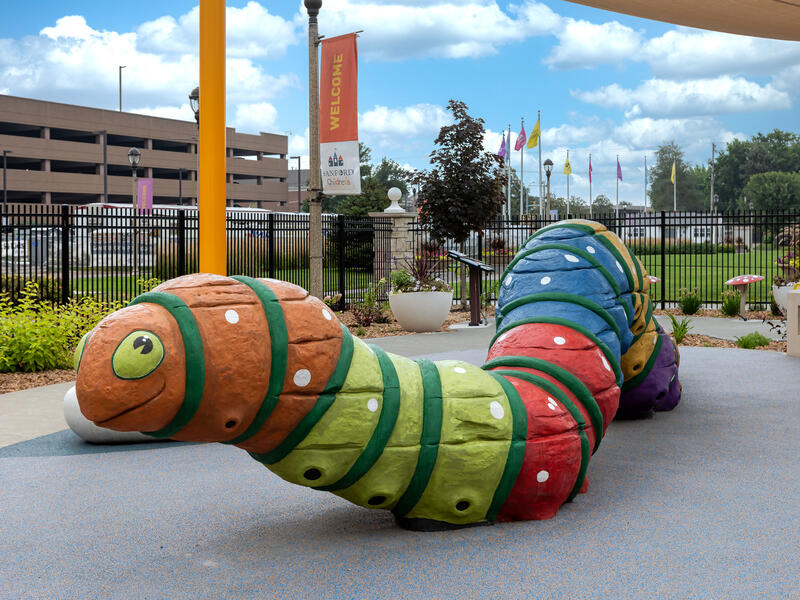 Giant caterpillar climbing toy on a playground.