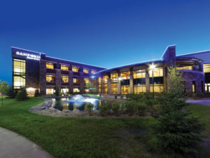 Nighttime view outside three-story Sanford Aberdeen Medical Center.