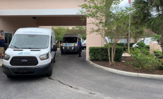 Three vans line the driveway and overhang of a Good Samaritan Society nursing home in Florida.