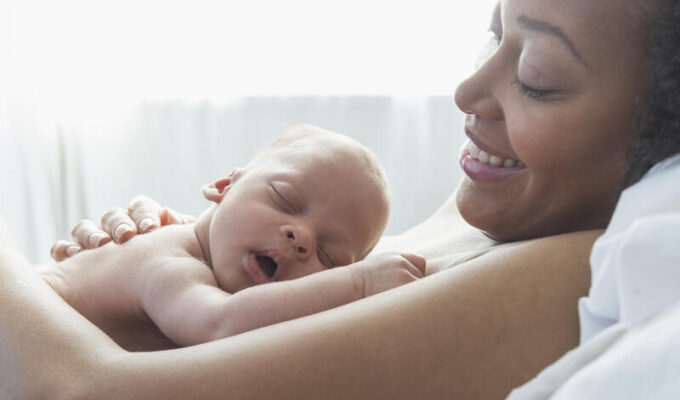 mother holding newborn baby in hospital