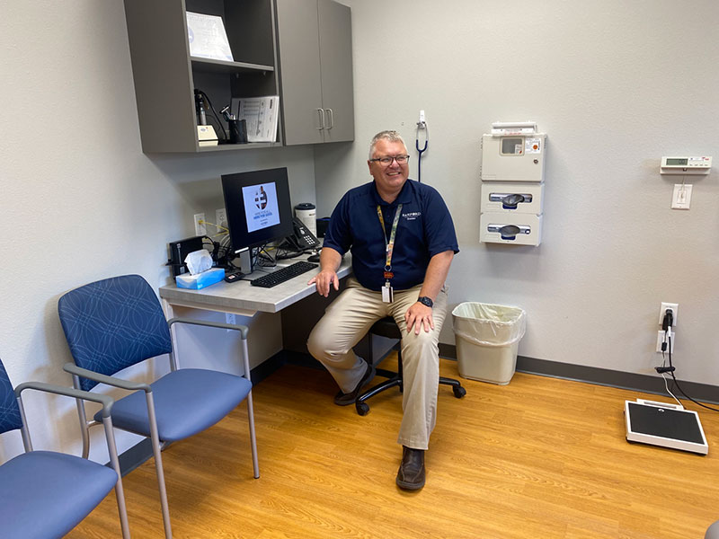 Dr. Scott Lichty sits in a new exam room at Sanford Sheldon Clinic.