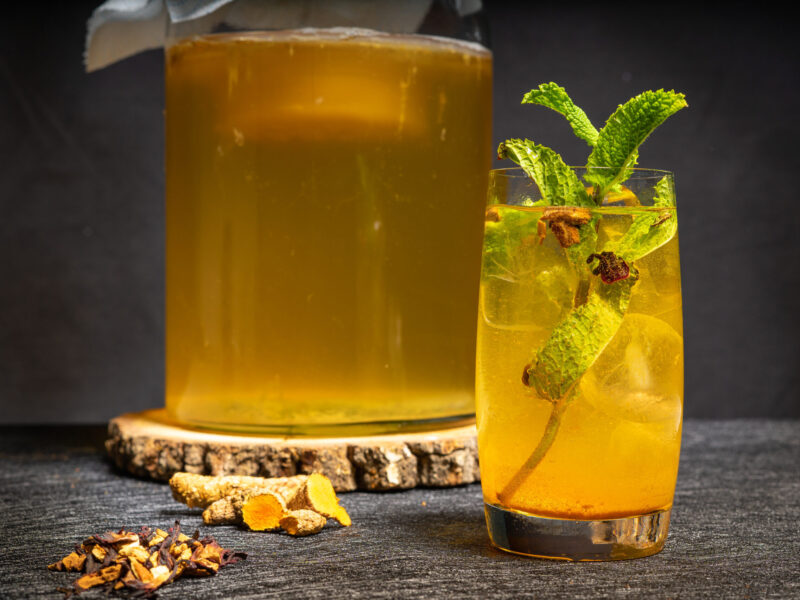 Homemade fermented kombucha tea curcuma flavor. Healthy natural drink with probiotic flavor.