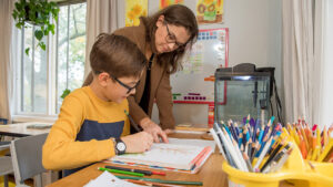 Young boy who screened for type 1 diabetes does homework with his mother.