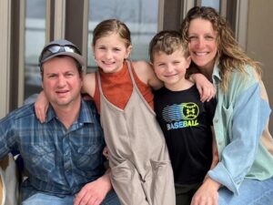 family poses together for photo