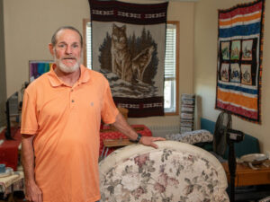 Formerly homeless man stands in his new apartment