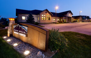 Black Hills Imaging Center exterior at night, with peaks of the building echoing the mountain peaks on the sign.