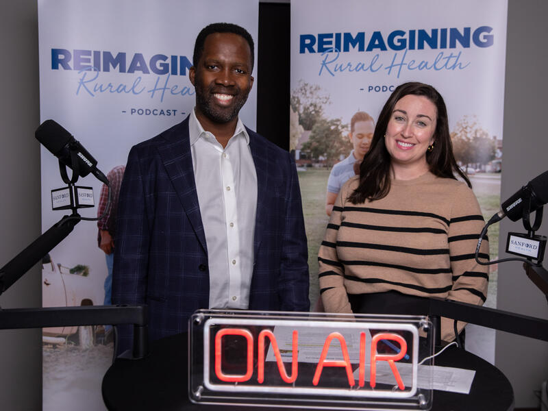 Man and woman with microphones recording a podcast