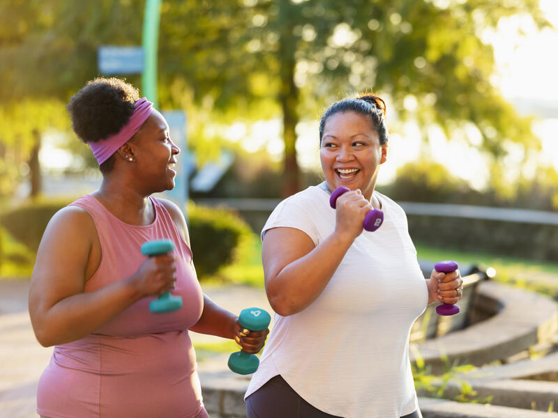 Two multiracial women exercising in city, jogging