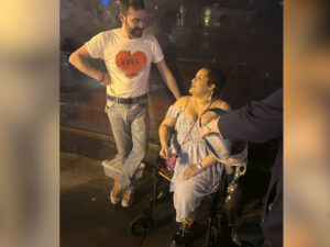 Bearded man meets woman in wheelchair in happy conversation.