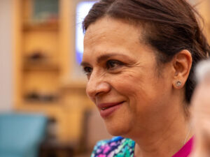 Side view portrait of certified nursing assistant smiling.