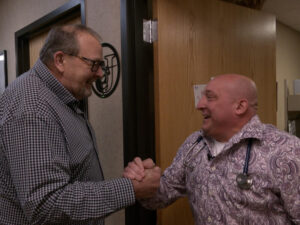 Lung cancer screening patient and doctor shake hands and smile