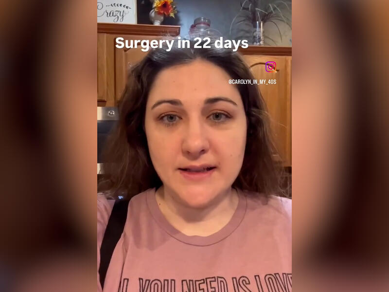 Woman in t-shirt speaks straight to the camera with text above her head saying "Surgery in 22 days." Beside her face is her Instagram handle.