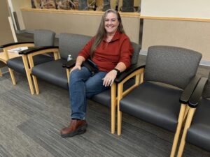 Middle-aged woman sits in mammograms waiting room.