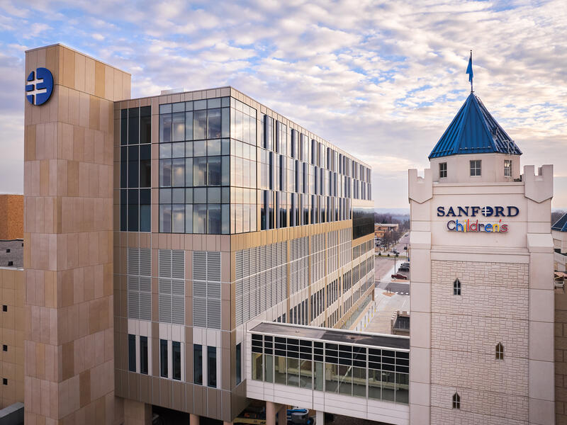 Exterior of Sanford Orthopedic Hospital and Sanford Children's Hospital towers with walkway between them.