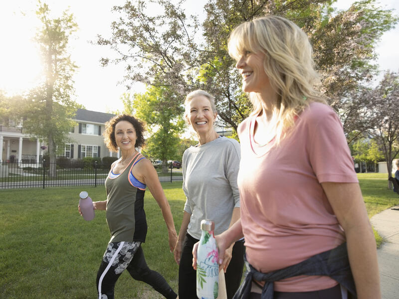 three women walking outside and talking