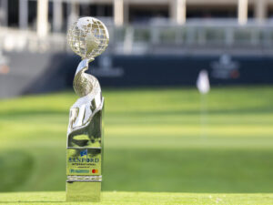 Silver golf trophy on display on a golf green.