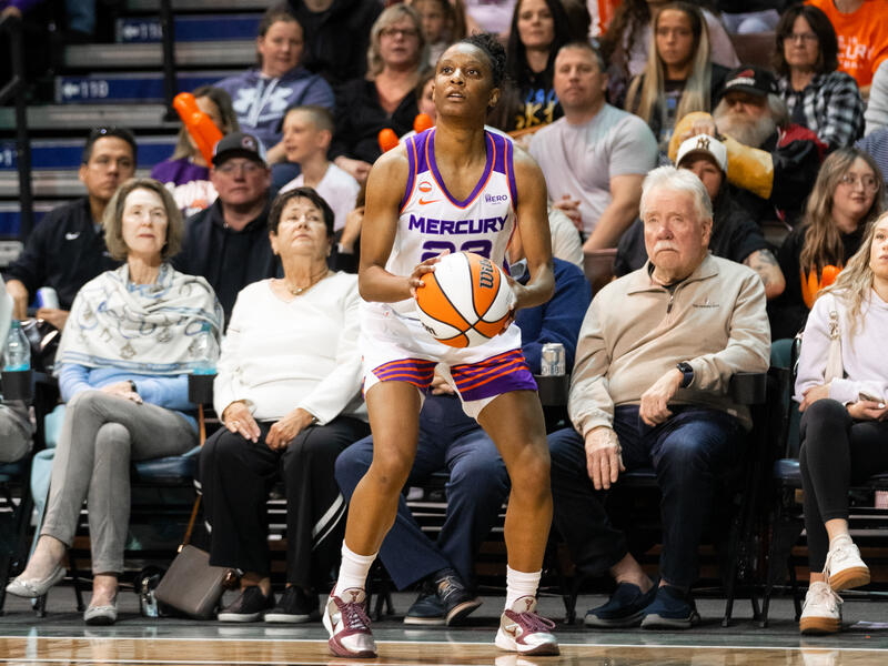 Phoenix Mercury basketball player prepares to shoot the ball.