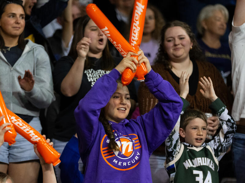 Fans in the stands cheer for the Phoenix Mercury WNBA team.