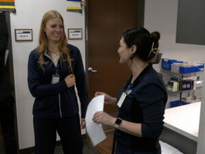 Becky Nelson fellowship nurse speaks with colleague