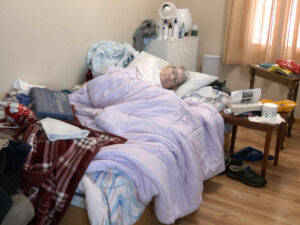 Hypoxia patient lies in bed at home