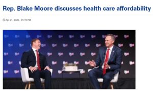 Two businessmen on stage at American Hospital Association.