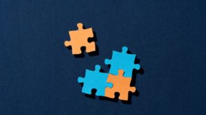 Screenshot from Medcity News with puzzle pieces illustrating mergers