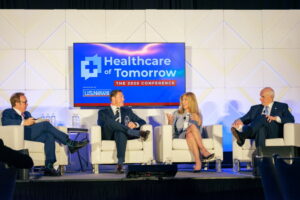 Four businesspeople on stage at Healthcare of Tomorrow conference