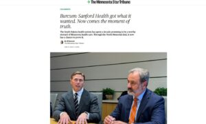 Screenshot from Minnesota Star-Tribune. Two businessmen at a conference room table under headline "Burcum: Sanford Health got what it wanted. Now comes the moment of truth."