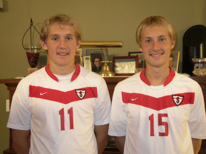 Two teen soccer players in their living room.