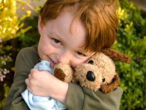 Boy Toddler Hugging Dog Stuffed Animal, Child Consoling with Blanket.