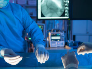 Close up of surgeons' hands with a heart stent.