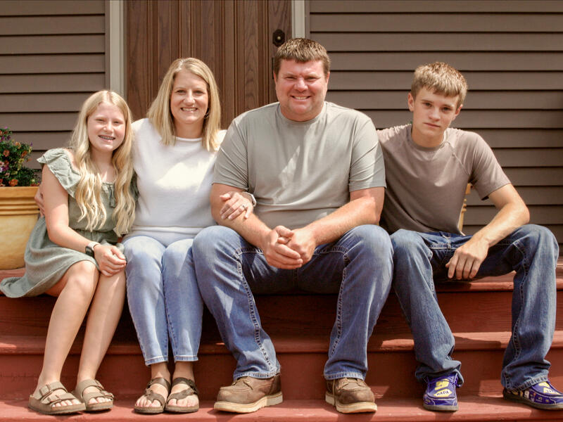 Family of four on front steps.