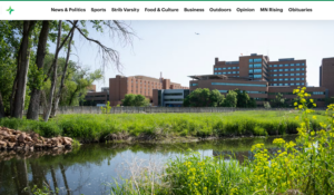 Hospital campus with a lake in foreground.